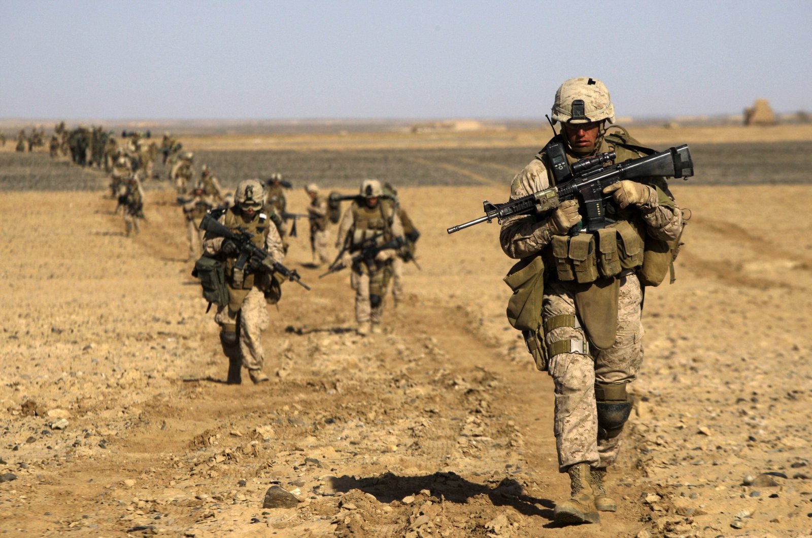 U.S. Marines from 3rd Battalion, 6th Marine Regiment walk in a column as they enter Marjah in Afghanistan's Helmand province Saturday, Feb. 13, 2010. (AP Photo)