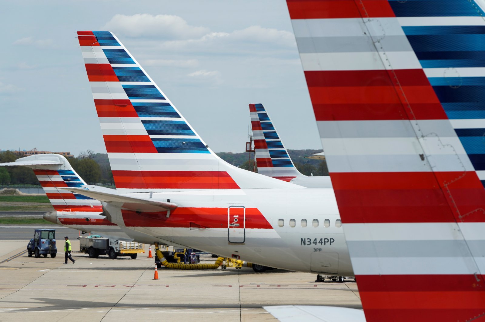 A member of a ground crew walks past American Airlines planes parked at the gate during the coronavirus outbreak at Ronald Reagan National Airport in Washington, U.S., April 5, 2020. (Reuters Photo)