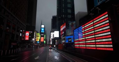 The U.S. Flag illuminates a street in Times Square amid the COVID-19 pandemic, in New York City, April 30, 2020. (AFP Photo)