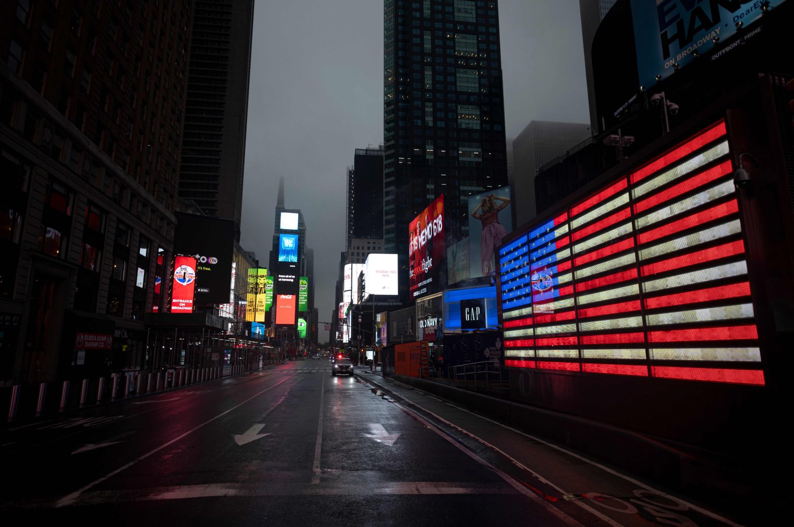 The U.S. Flag illuminates a street in Times Square amid the COVID-19 pandemic, in New York City, April 30, 2020. (AFP Photo)
