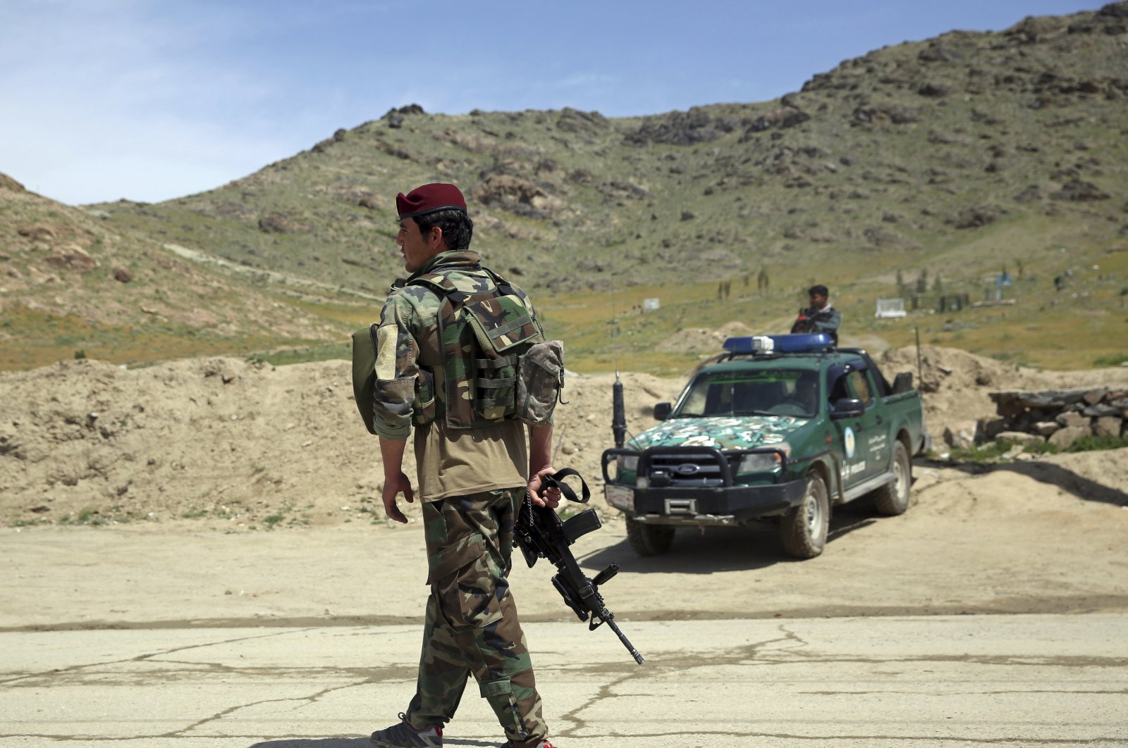 Afghan security personnel stand guard at the site of a suicide bomber attack on the southern outskirts of Kabul, Afghanistan, Wednesday, April 29, 2020. (AP Photo)