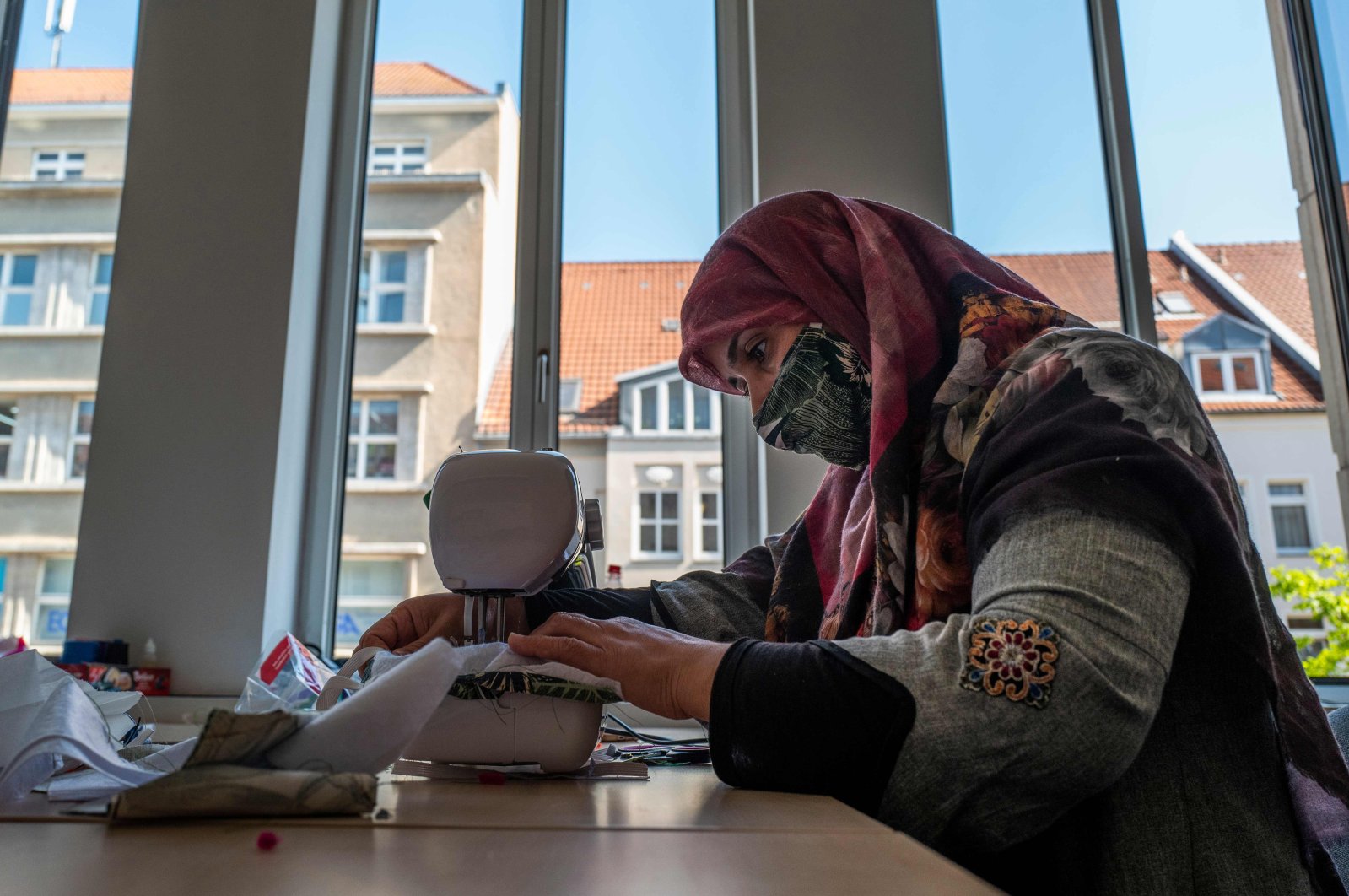 A refugee from Afghanistan sews face covers  amid the COVID-19 pandemic in Berlin, Germany on April 23, 2020. (AFP Photo)