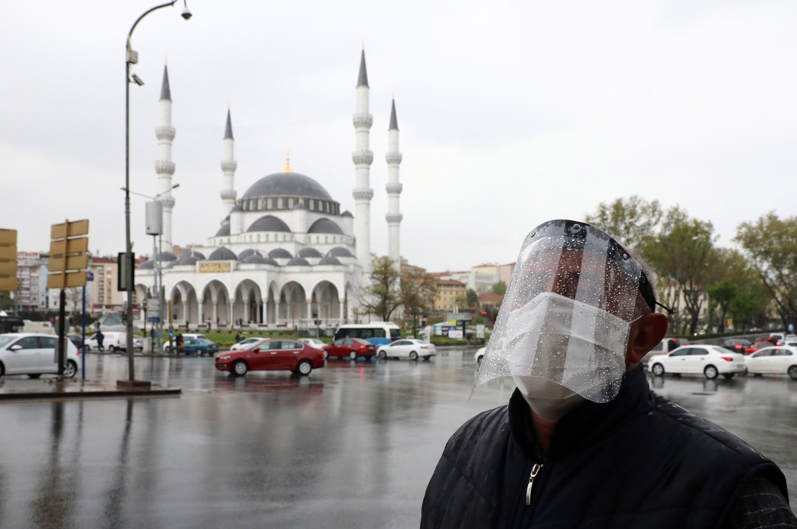 A man wearing a face-shield for protective measures crosses the streets as the spread of the COVID-19, the novel coronavirus continues in Ankara, on April 30, 2020. (AFP Photo)