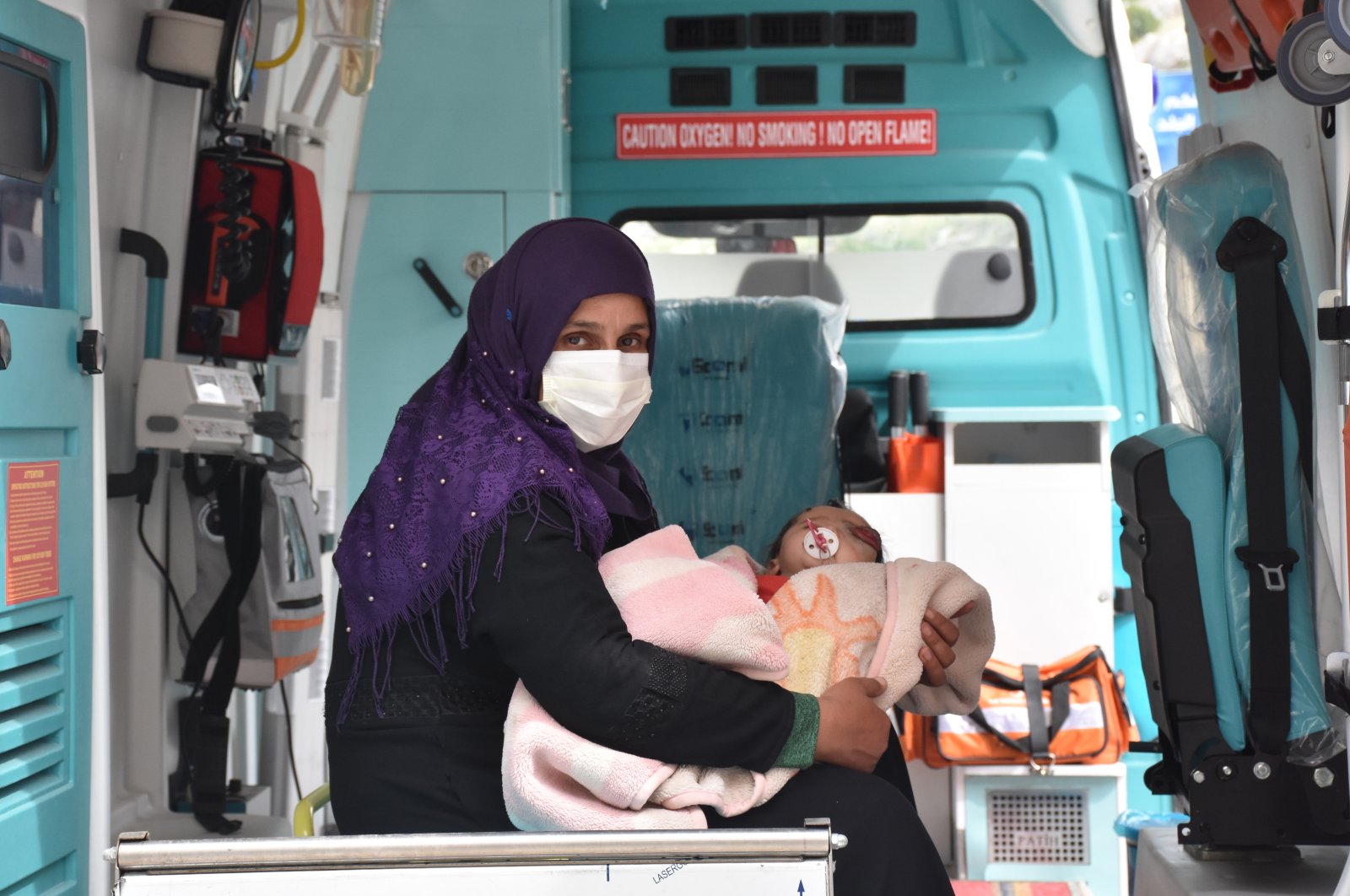 Yusuf and his mother ride in an ambulance sent by the Hatay Governorate to pick them up at the Cilvegözü Border Gate in the Reyhanlı district of Hatay, Turkey, May 3, 2020. (AA Photo)