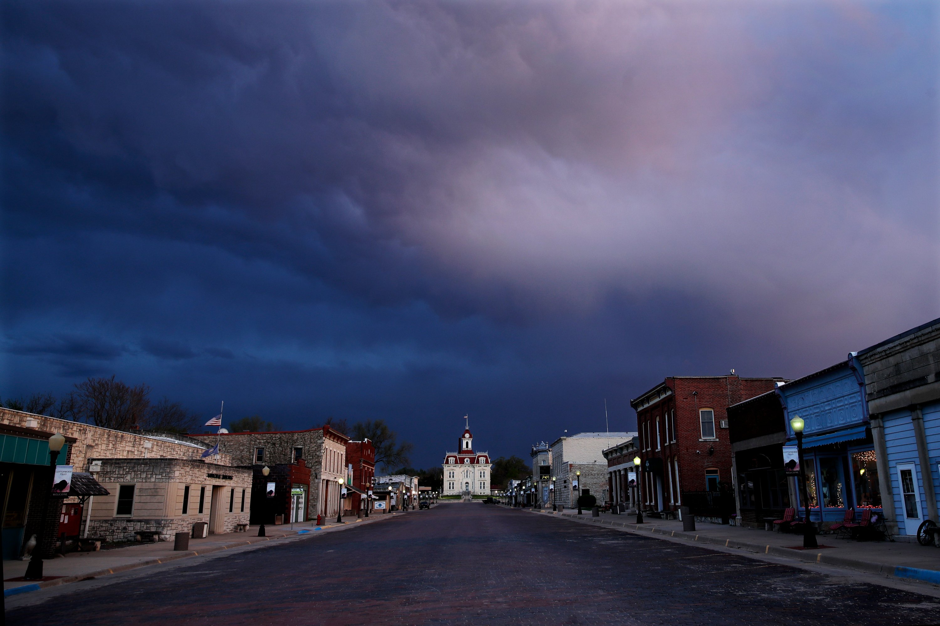  In this April 23, 202, file photo, a deserted street leads to the historic Chase County Courthouse at dusk in Cottonwood Falls, Kan. (AP Photo)