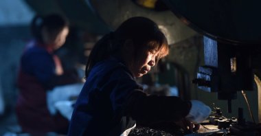 Employees work on a production line manufacturing metal parts for furniture at a factory in Hangzhou, Zhejiang province, China, April 30, 2020. (China Daily via REUTERS)