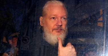 Julian Assange gestures as he arrives at Westminster Magistrates' Court, London, Britain, April 11, 2019. (AP Photo)