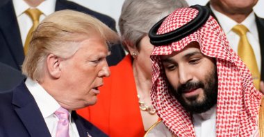 U.S. President Donald Trump speaks with Saudi Arabia's Crown Prince Mohammed bin Salman during a family photo session with other leaders and attendees at the G20 leaders summit in Osaka, Japan, June 28, 2019.  (REUTERS Photo)