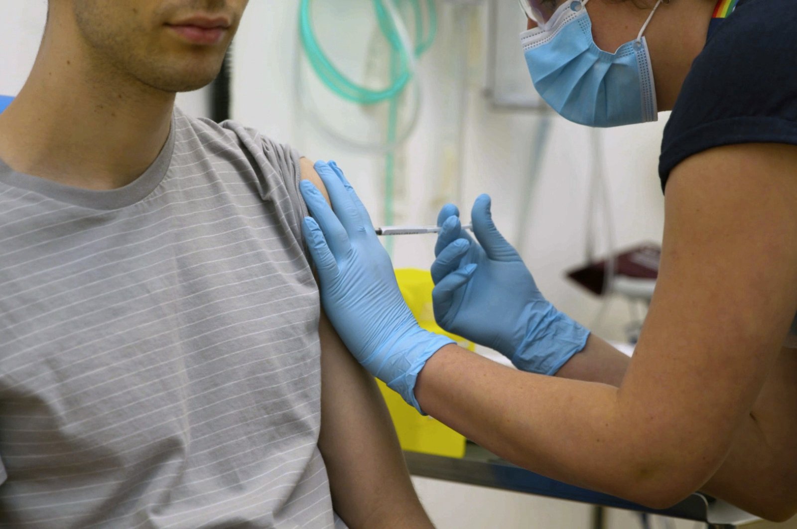 In this screen grab from video issued by Britain's Oxford University, a volunteer is injected with either an experimental COVID-19 vaccine or a comparison shot as part of the first human trials in the U.K. to test a potential vaccine, led by Oxford University in England on April 25, 2020. (University of Oxford via AP)