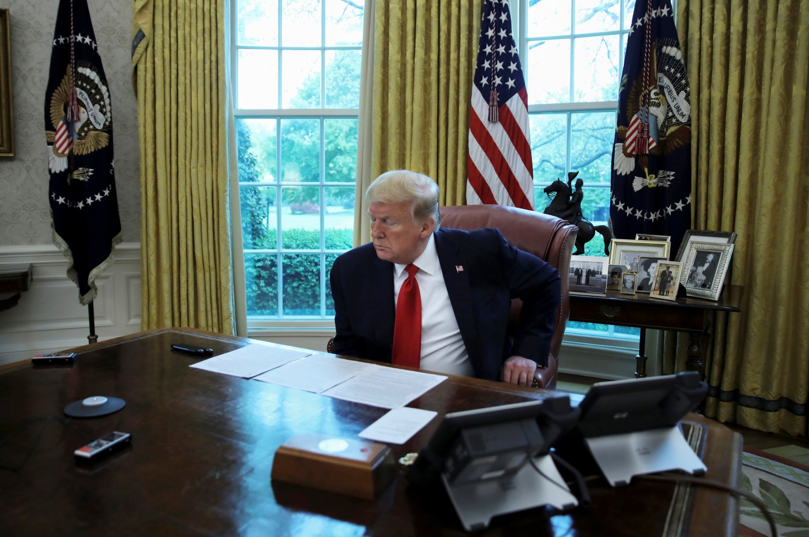 U.S. President Donald Trump looks at his briefing papers at the start of an interview with Reuters about China, in the Oval Office of the White House in Washington, D.C., U.S., April 29, 2020. (Reuters Photo)