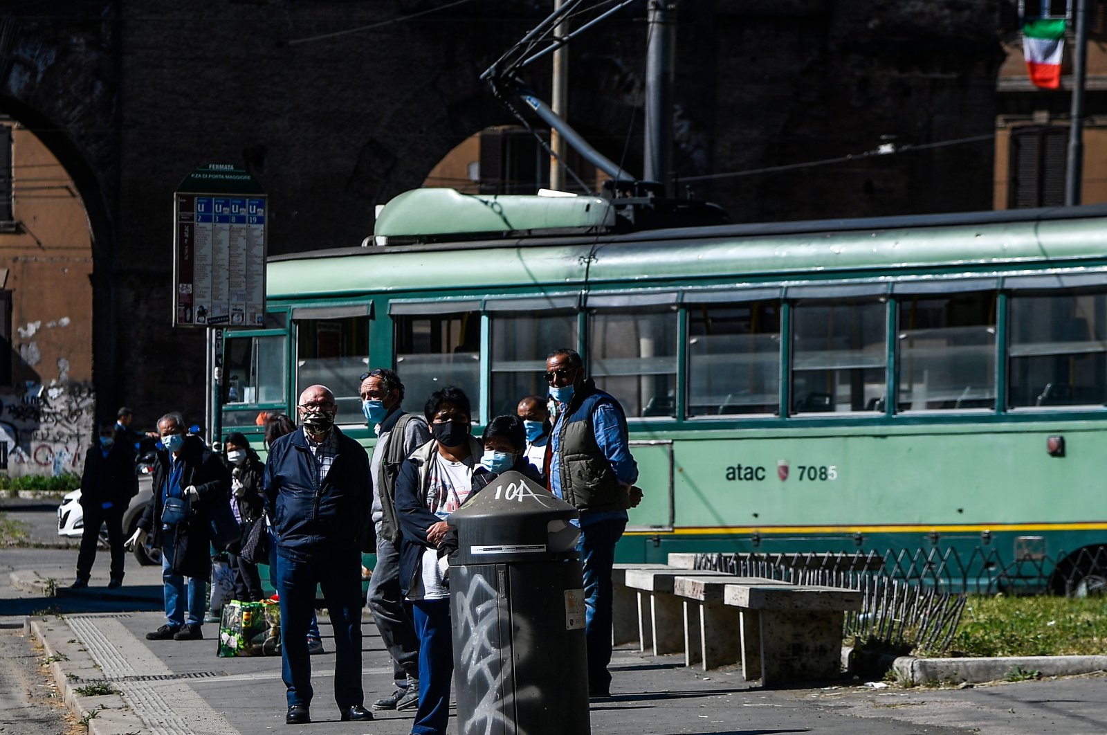 Commuters wait for the tramway at Porta Maggiore in Rome, as Italy starts to ease its lockdown aimed at curbing the spread of COVID-19, May 4, 2020. (AFP Photo)
