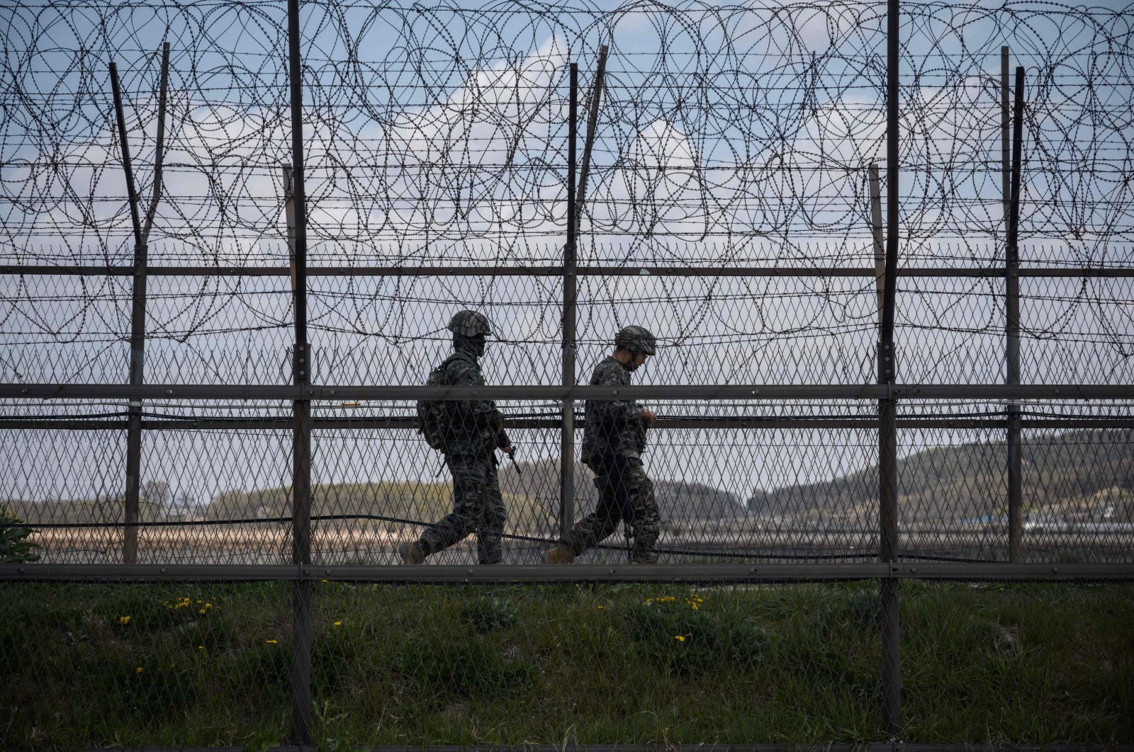 South Korean soldiers patrolling along a barbed wire fence Demilitarized Zone (DMZ) separating North and South Korea, on the South Korean island of Ganghwa, April 23, 2020. (AFP Photo)