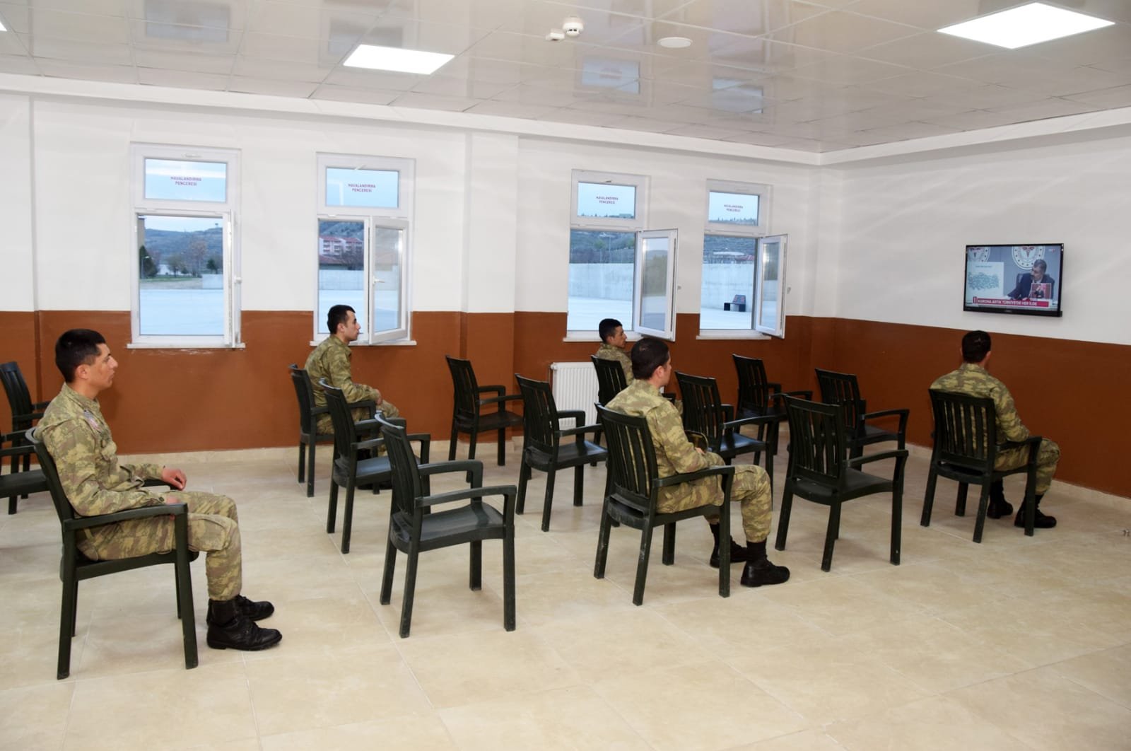 Turkish military soldiers watching TV in a military mess while keeping social distancing, May 3, 2020. (AA)