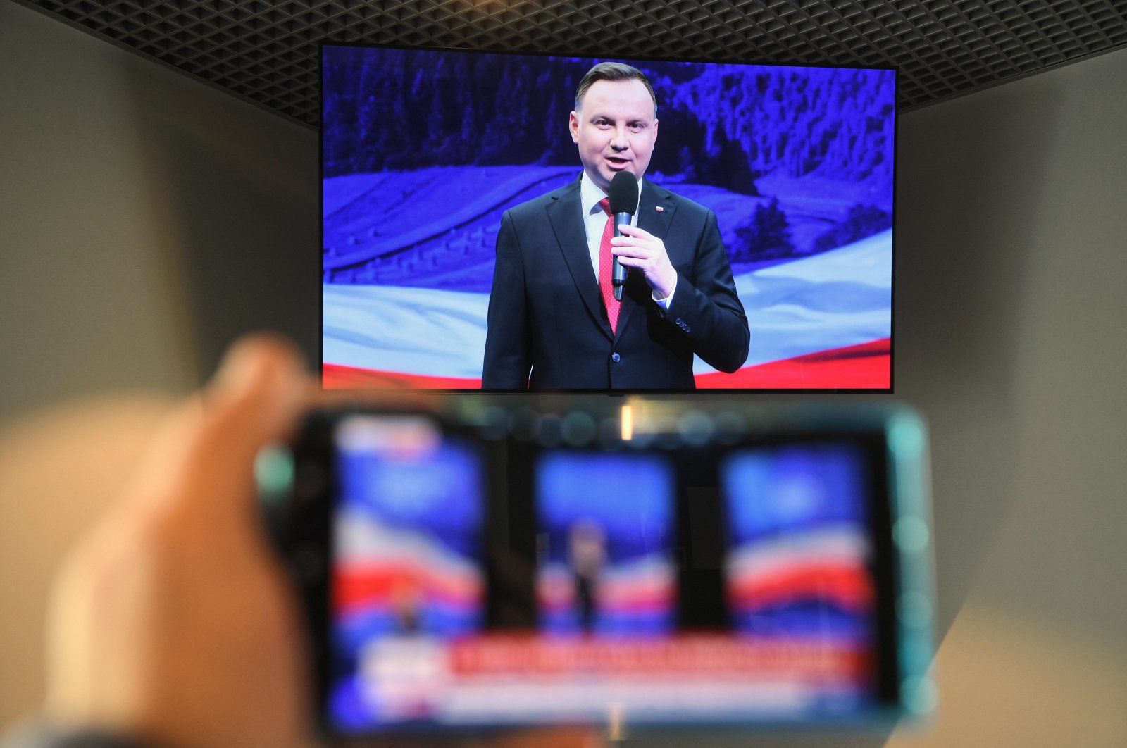 A television screen shows Polish President Andrzej Duda during the broadcast from the program convention in the village of Szeligi, Poland on May 1, 2020. (EPA Photo)