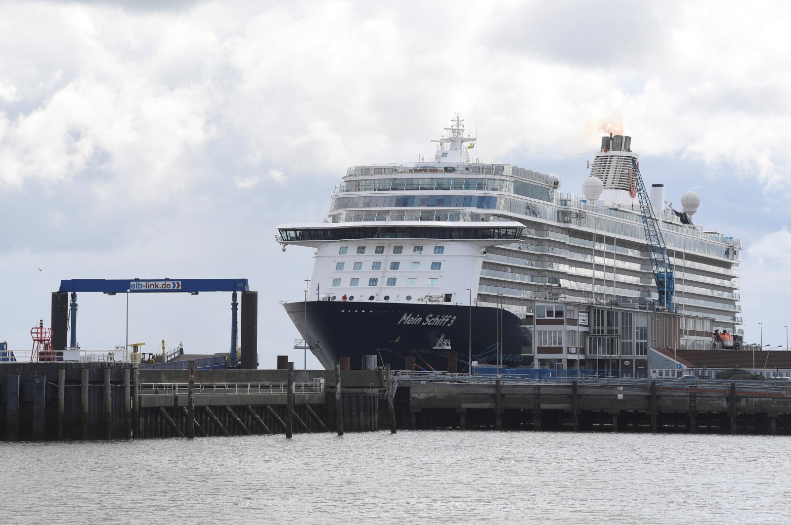 Cruise ship Mein Schiff 3 sits in the harbor with nearly 3,000 travel agency TUI staff members quarantined onboard, according to local media, during the coronavirus pandemic, Cuxhaven, Germany, May 2, 2020. (Reuters Photo)