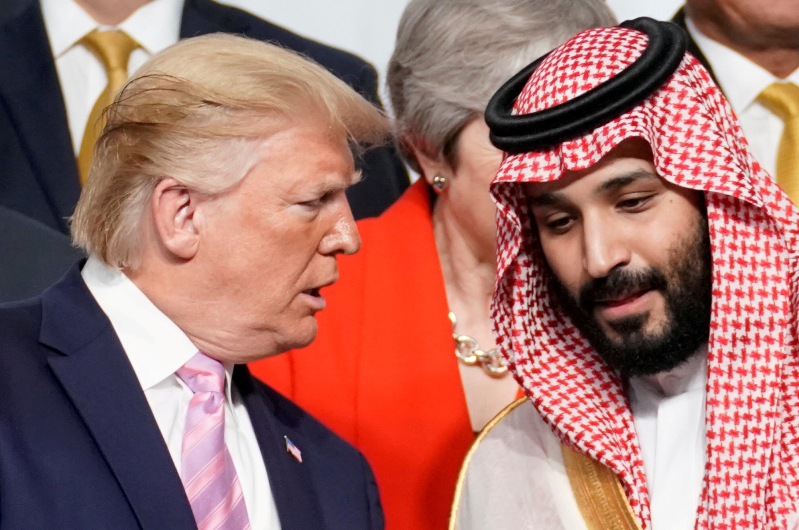 U.S. President Donald Trump speaks with Saudi Arabia's Crown Prince Mohammed bin Salman during a family photo session with other leaders and attendees at the G20 leaders summit in Osaka, Japan, June 28, 2019.  (REUTERS Photo)