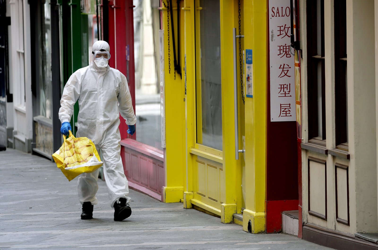 A man wears full protective equipment to protect against the coronavirus as he shops in London, Monday, May 4, 2020, as the UK enters a seventh week of lockdown to help stop the spread of coronavirus. (AP Photo)