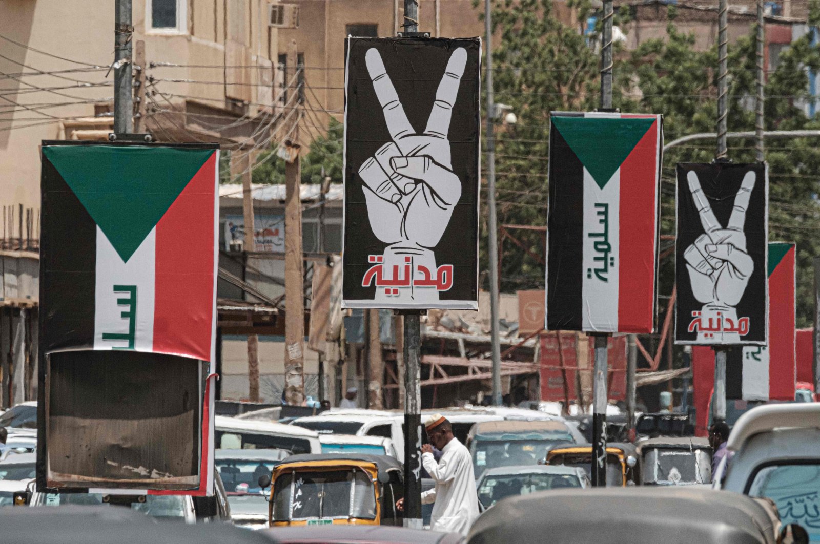 Placards showing the victory gesture with the Arabic word for civilian and others of the Sudanese flag with the word peaceful seen along a street in Khartoum, Sudan, June 15, 2019. (AFP Photo)