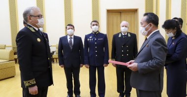 Russian Ambassador to the Democratic People's Republic of Korea Alexander Matsegora (L) and DPRK Foreign Minister Ri Son-gwon (R), both wearing face masks to protect against the novel coronavirus, attend a ceremony awarding North Korean leader Kim Jong-un with Russia's 75th anniversary Victory medal for his major contribution in commemorating Soviet soldiers, Pyongyang, North Korea, May 5, 2020. (AP Photo)