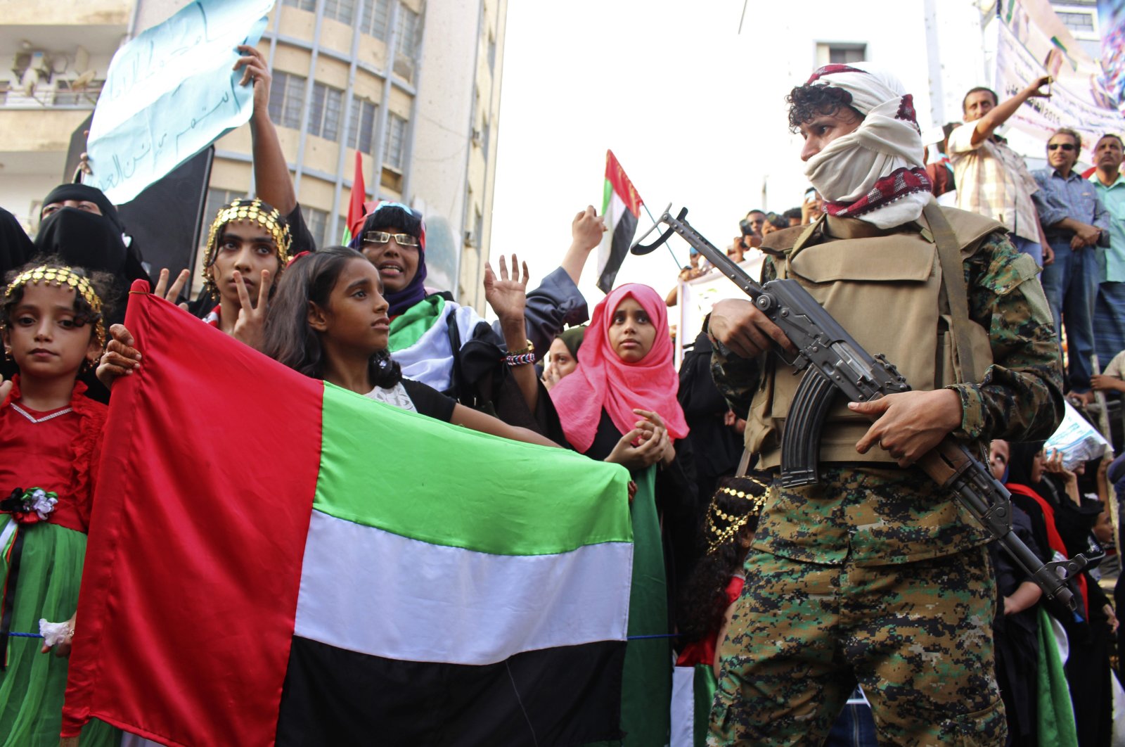 A girl holds the flag of the United Arab Emirates during a rally of supporters of southern separatists to show support for the UAE amid a standoff with the internationally recognized government, in Aden, Yemen, Sept. 5, 2019. (AP Photo)