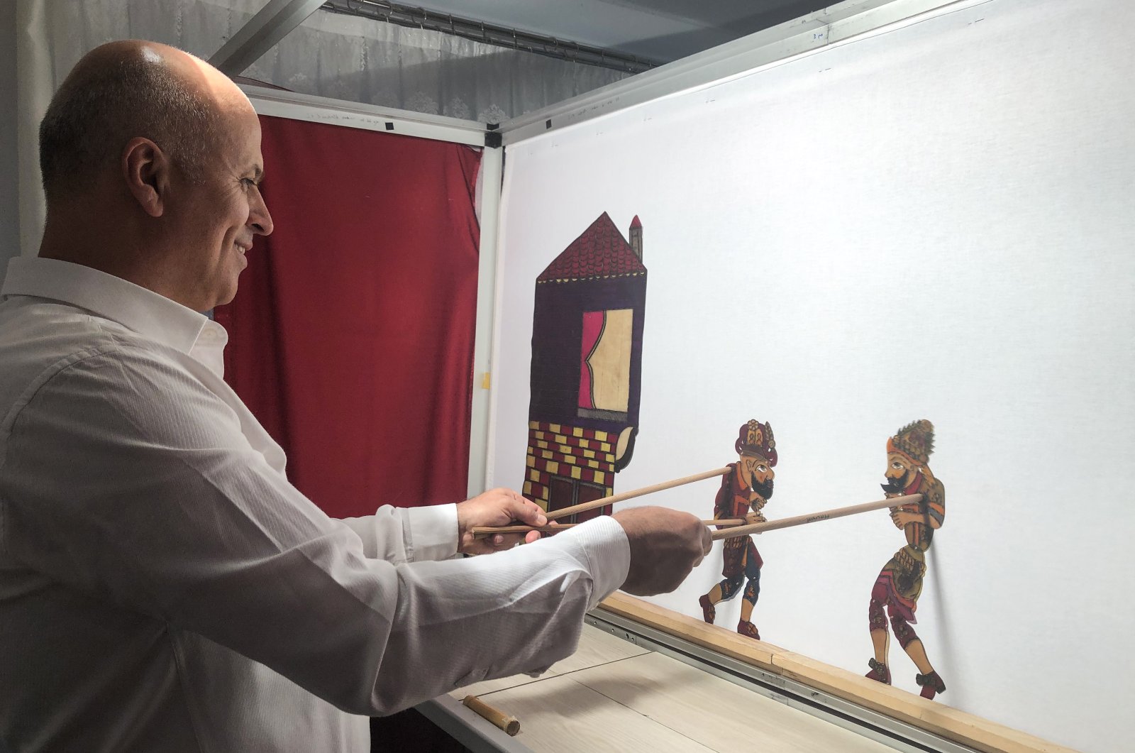 Suat Veral performs a shadow play with the Karagöz and Hacivat characters, in this undated photo. (AA Photo)