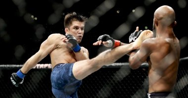 Henry Cejudo kicks Demetrious Johnson during their UFC flyweight title mixed martial arts bout at UFC 227 in Los Angeles, Aug. 4, 2018. (AP Photo)