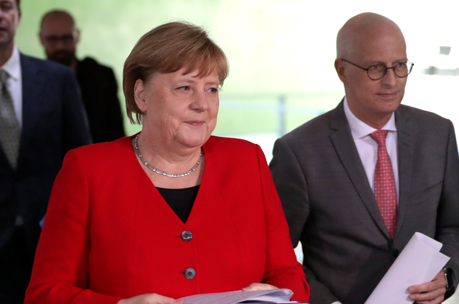 German Chancellor Angela Merkel (L) and Peter Tschentscher, First Mayor of Hamburg, arrive at a news conference after an online meeting with German state governors on the loosening of the restrictions to reduce the spread of the coronavirus disease (COVID-19), Berlin, Germany, May 6, 2020. (Reuters Photo)