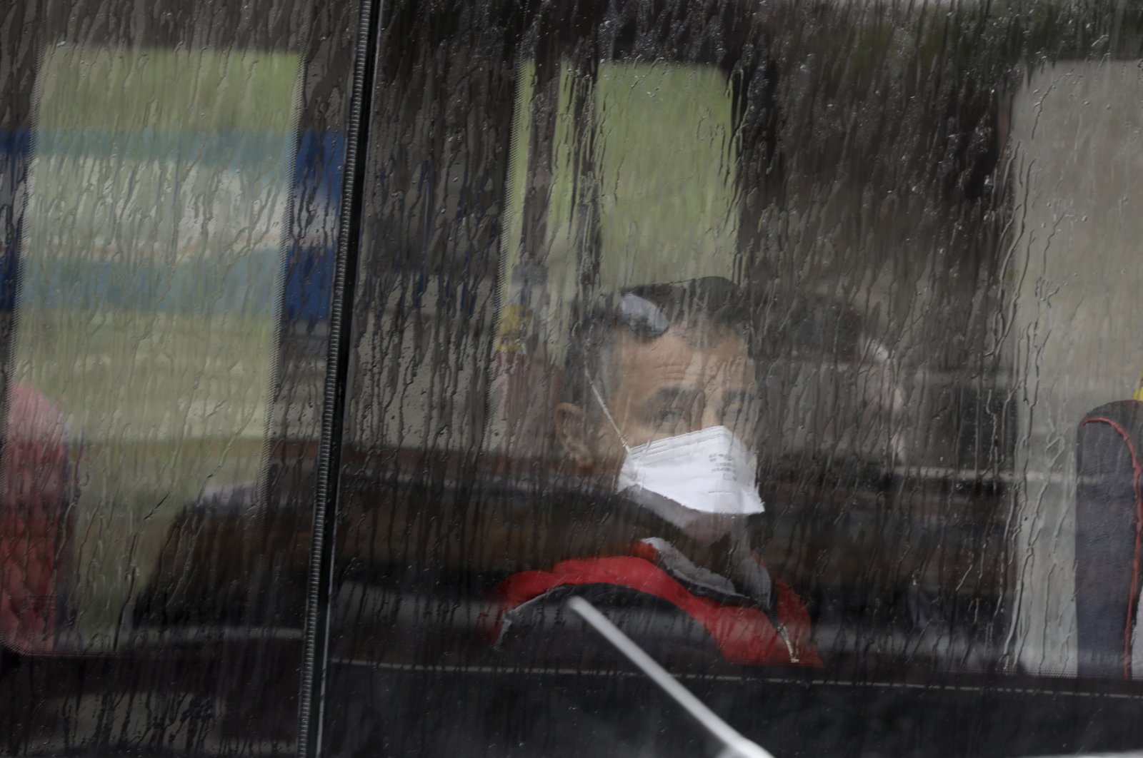 A man wearing a face mask, for protection against the coronavirus, sits on a bus in Ankara, Turkey, Tuesday, May 5, 2020.