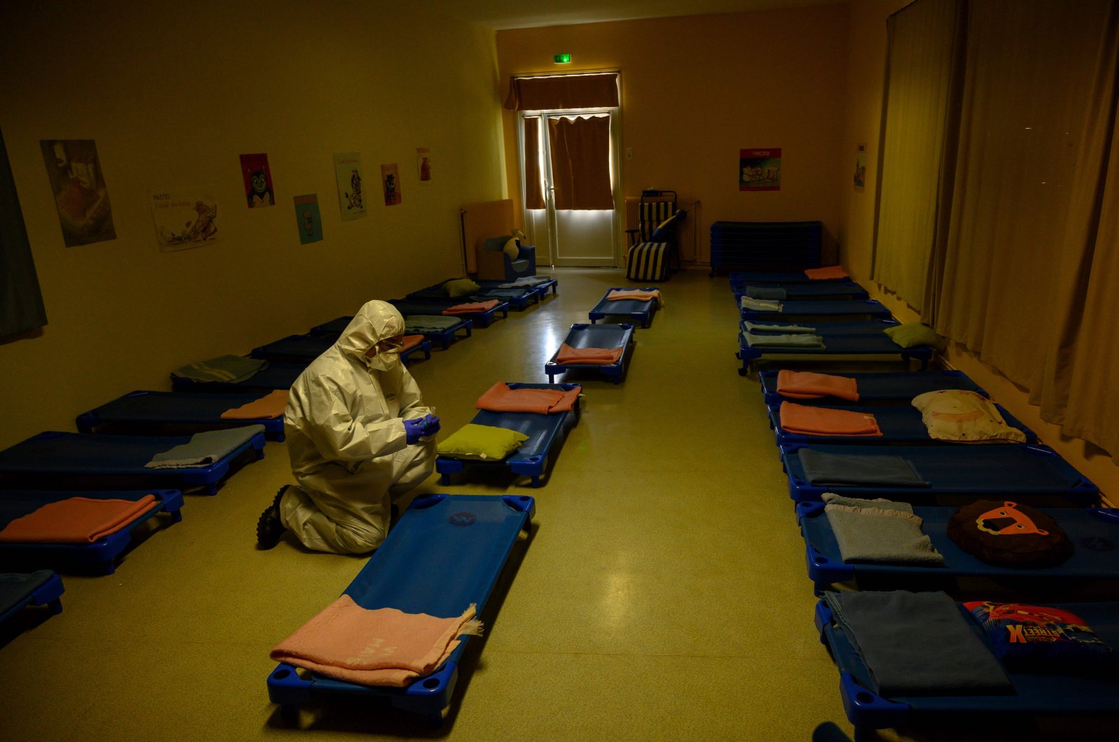 A French fireman collects sample in the sleeping room of a school of Marseille to control the possible presence of the coronavirus, on May 5, 2020, as the schools in France are to gradually reopen from May 11, when a partial lifting of restrictions due to the COVID-19 pandemic caused by the novel coronavirus comes into effect. (AFP Photo)