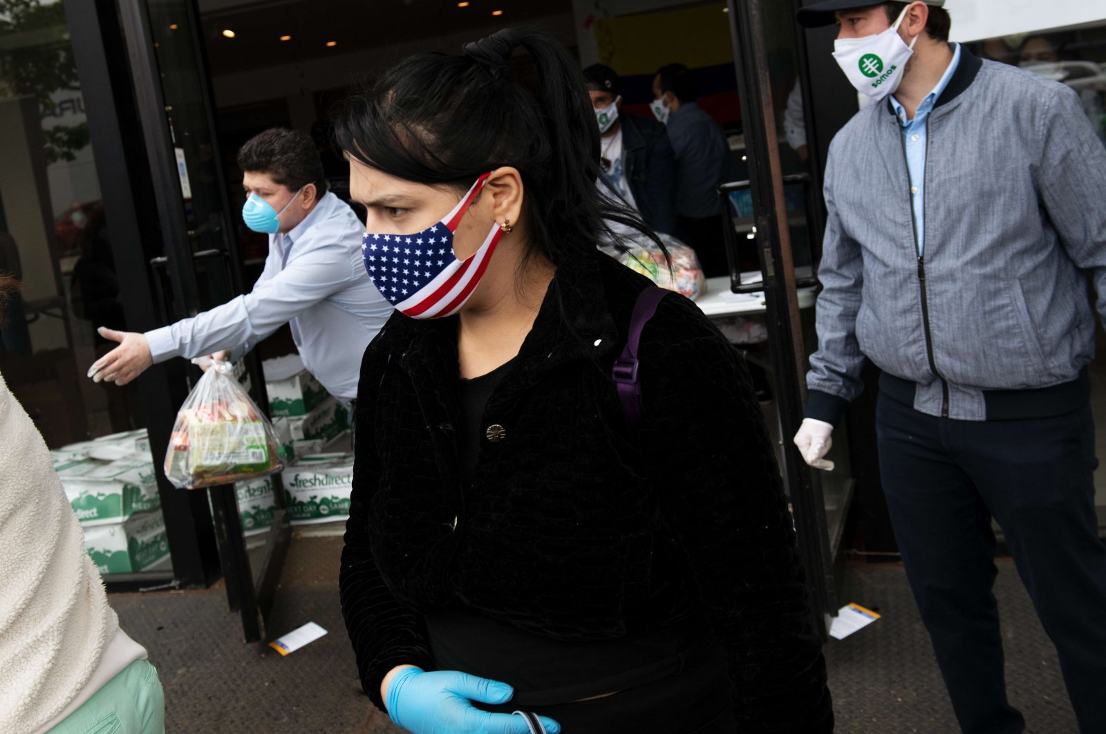 A woman leaves a food donation center after receiving donated groceries on May 6, 2020 in the Queens borough of New York City. (AFP Photo)