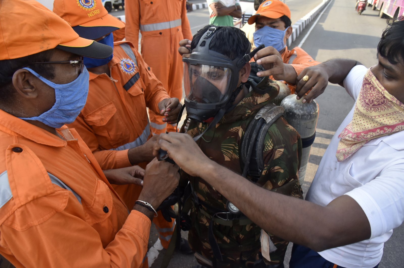 A National Disaster Response Force (NDRF) soldier is fitted with gear before he proceeds to the area from where chemical gas leaked in Vishakhapatnam, India, Thursday, May 7, 2020. (AP Photo)