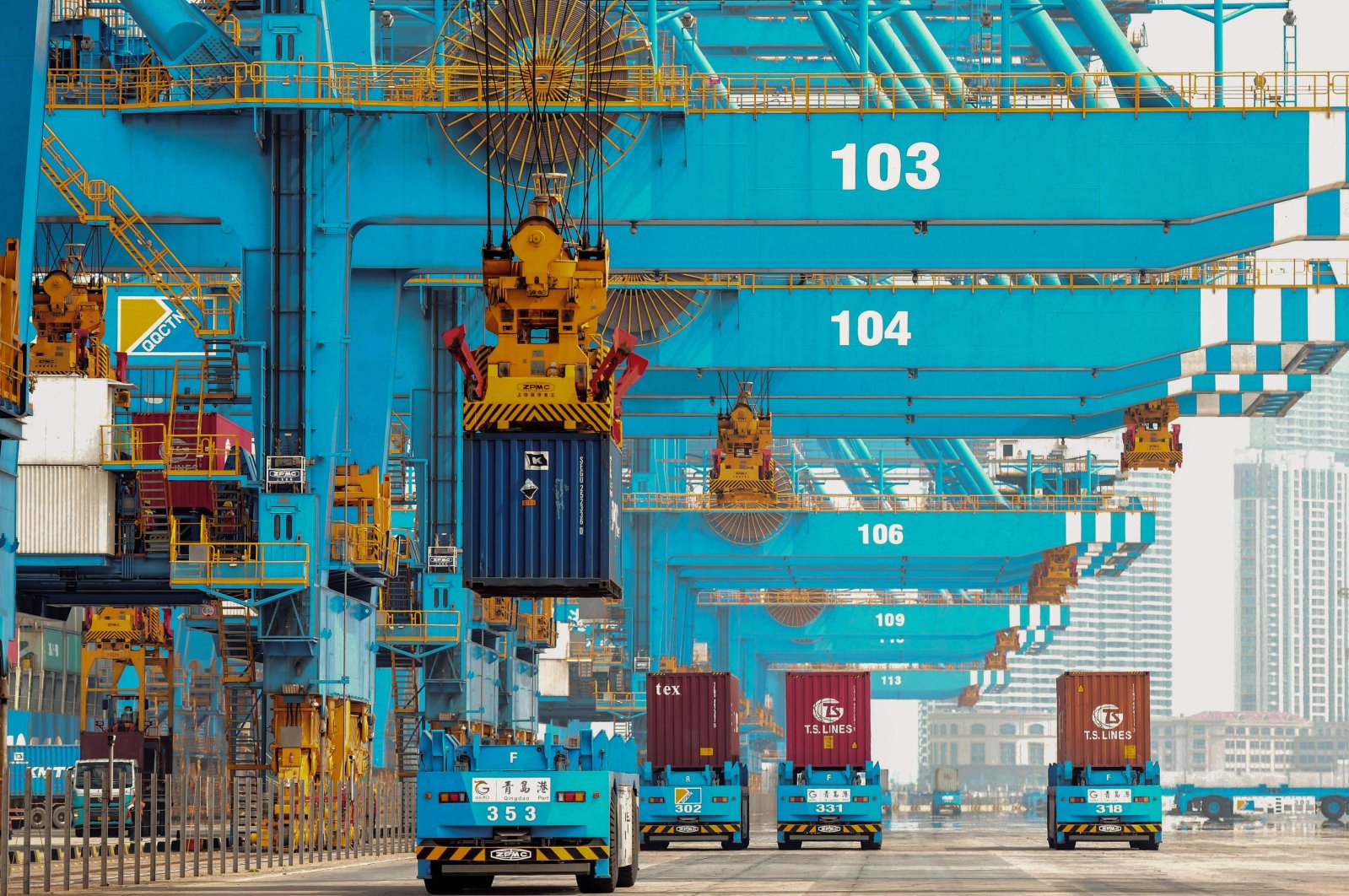 Trucks transporting containers at a port in Qingdao in China's eastern Shandong province, March 31, 2020. (AFP Photo)