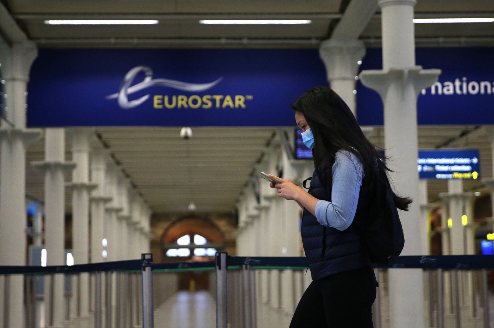 A passnger wearing a facemask arrives at the Eurostar terminal at St Pancras station in London on May 6, 2020 as life continues under a nationwide lockdown imposed to slow the spread of the novel coronavirus. (AFP Photo)