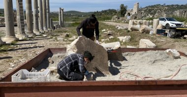 The excavation team works on the inscription in this undated photo. (AA Photo)