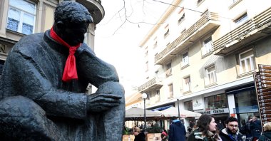 People walk past a statue of Nikola Tesla, one of the pioneers of modern electrical engineering, with a red tie knotted around the neck symbolizing Croatia's taking over the EU's rotating presidency of the EU Council, in central Zagreb, Jan. 3, 2020. (AFP Photo)