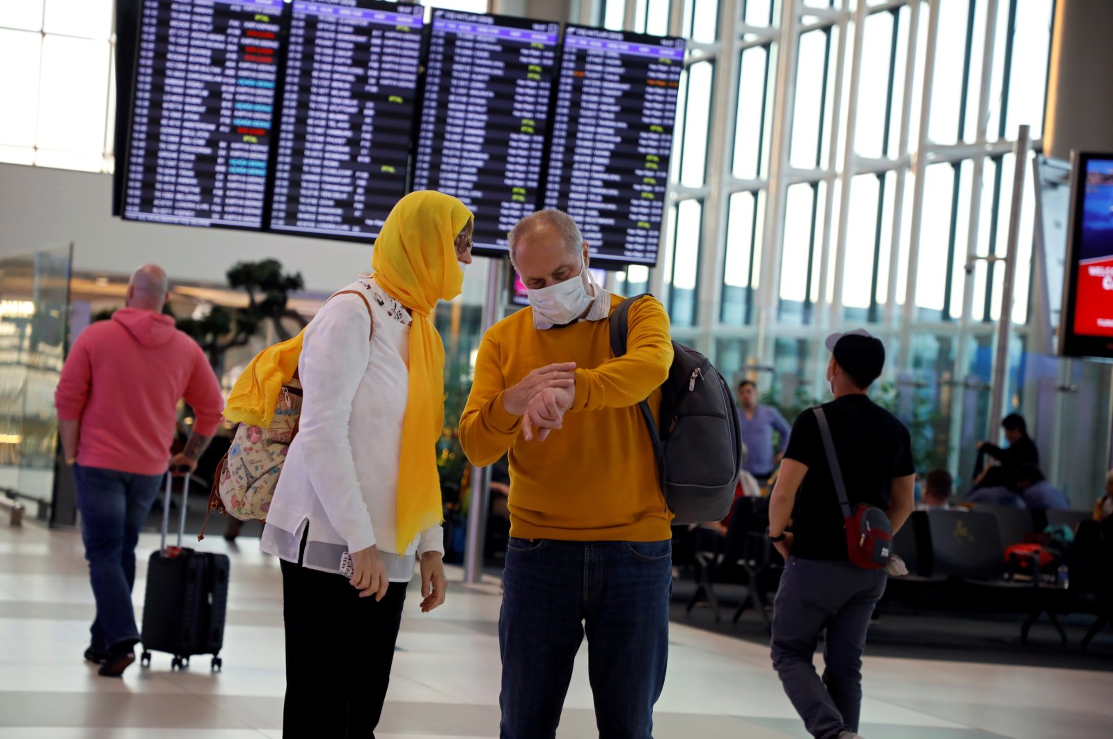 People wear protective face masks in light of the coronavirus pandemic, at Istanbul Airport, Istanbul, Turkey, March 13, 2020. (Reuters Photo)