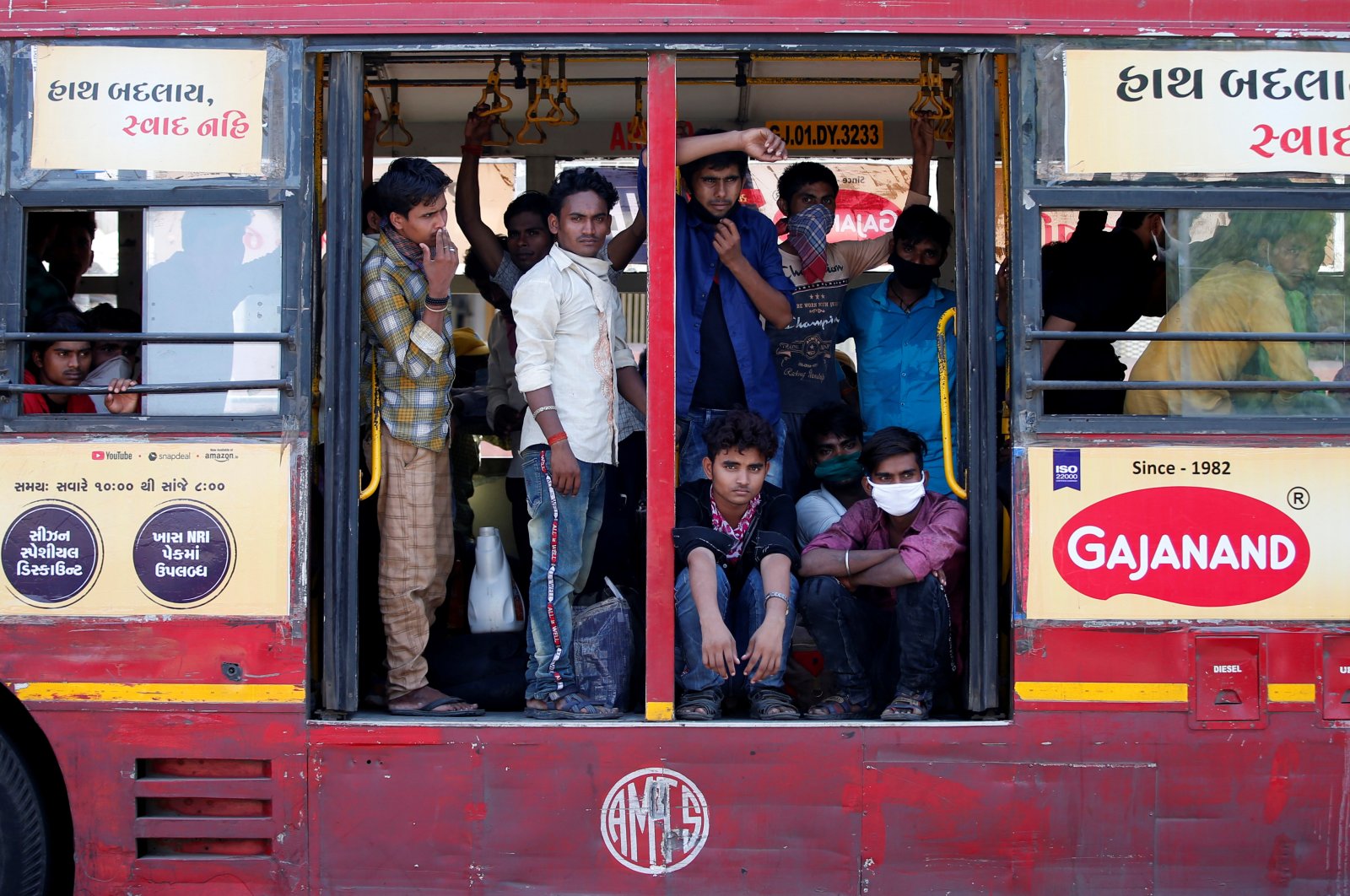 Migrant workers, who were stranded in the western state of Gujarat due to a lockdown imposed by the government to prevent the spread of the coronavirus, are seen inside a parked bus as they wait to board a train that will take them to their home state of eastern Bihar, in Ahmedabad, India, May 8, 2020. (Reuters Photo)