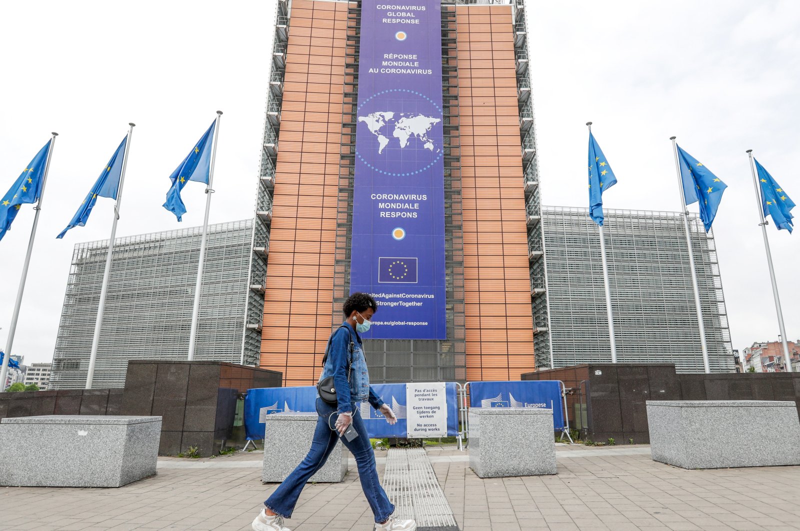 A woman walks in front the European Commission headquarters in Brussels, Belgium, May 4, 2020. (EPA Photo) 