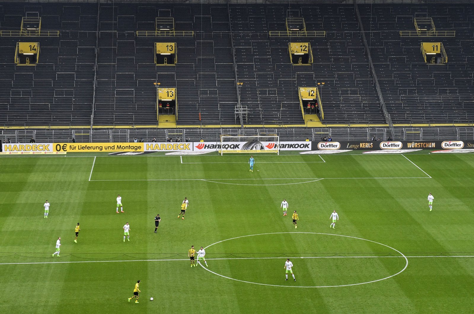 In this Feb. 18, 2017 file photo, players challenge for the ball in front of the empty south tribune because of a ban following fan trouble during the German Bundesliga football match between Borussia Dortmund and VfL Wolfsburg at Germany's biggest stadium in Dortmund, Germany. (AP Photo)