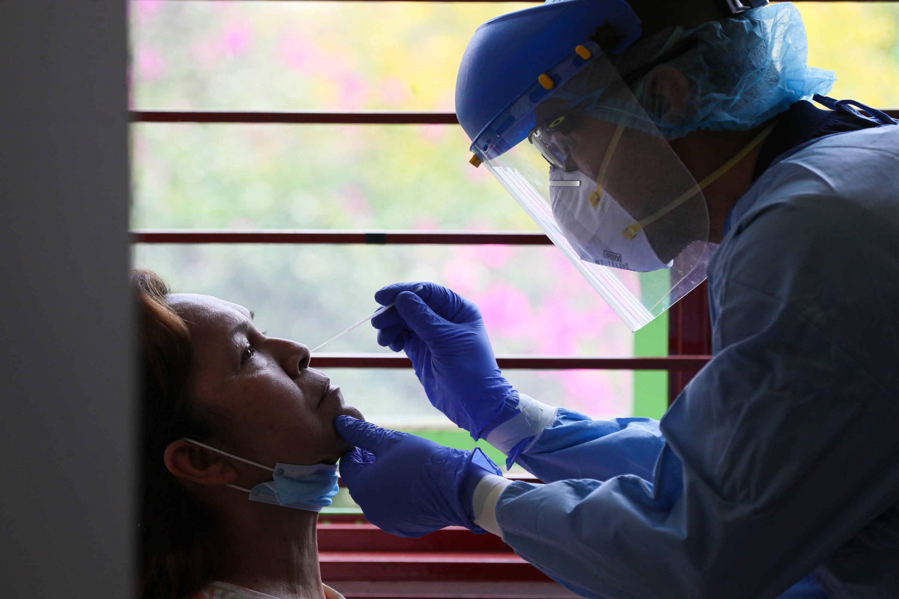 Jose Antonio Gama performs a nasal swab test on a patient at a medical center dedicated exclusively to the treatment of patients with COVID-19, in Mexico City, Saturday, May 9, 2020. (AP Photo)