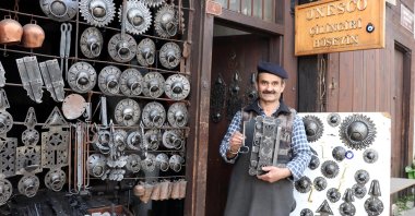 Master locksmith Hüseyin Şahin Özdemir poses with some of his works in front of his workshop on May 8, 2020 in Safranbolu. (AA Photo)