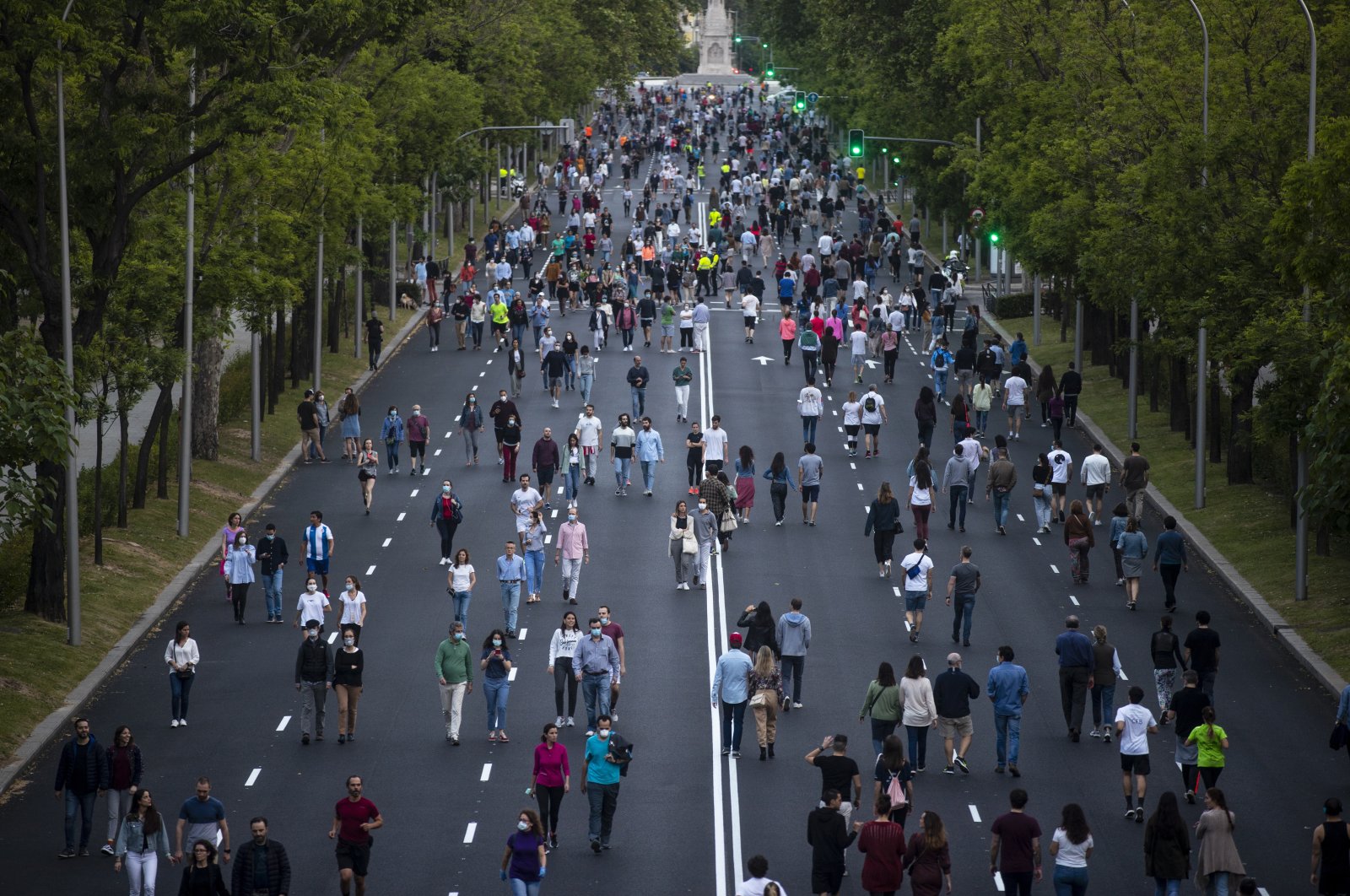 People exercise along Paseo de la Castellana after the lifting of coronavirus lockdown measures imposed by the government, Madrid, May 9, 2020. (AP Photo)