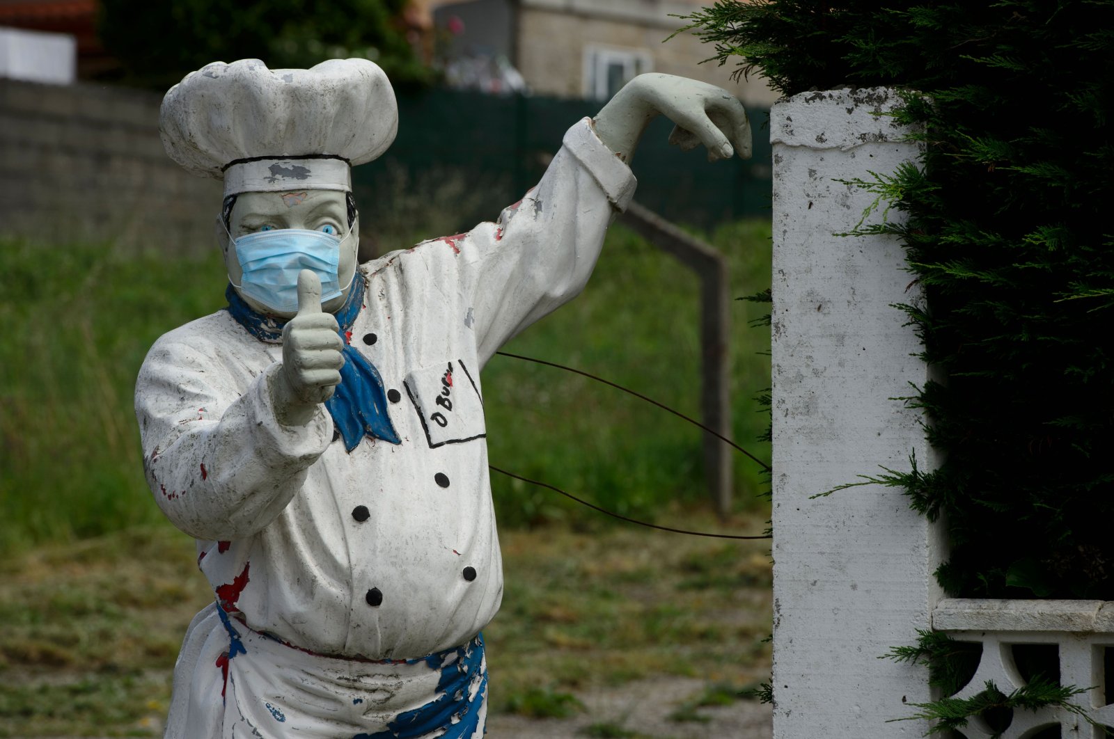 A statue of a cook wearing a face mask is pictured outside a restaurant in Vigo, on May 10, 2020 during the national lockdown to prevent the spread of the COVID-19 disease. (AFP Photo)