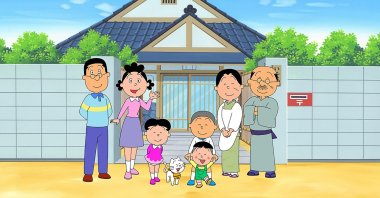 An image from the "Sazae-san" TV cartoon series, with the character, Sazae-san, (2nd L) and her family in front of their house, from the Hasagawa Michiko Art Museum in Tokyo, May 11, 2020. (AFP)