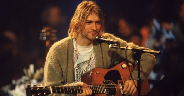 Kurt Cobain performs with his olive-green cardigan, which sold for $334,000 at an auction in 2019, at "MTV Unplugged" in New York, Nov. 18, 1993. (Getty Images)