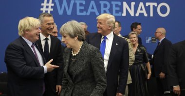 U.S. President Donald Trump jokes with Boris Johnson during a working dinner meeting at the NATO headquarters in May 25, 2017. (AP Photo) 