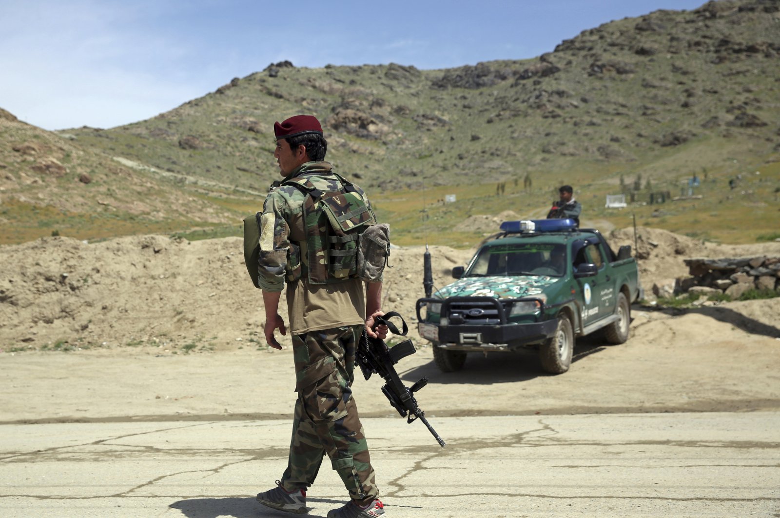 Afghan security personnel stand guard at the site of a suicide bomber attack on the southern outskirts of Kabul, Afghanistan, April 29, 2020. (AP Photo)