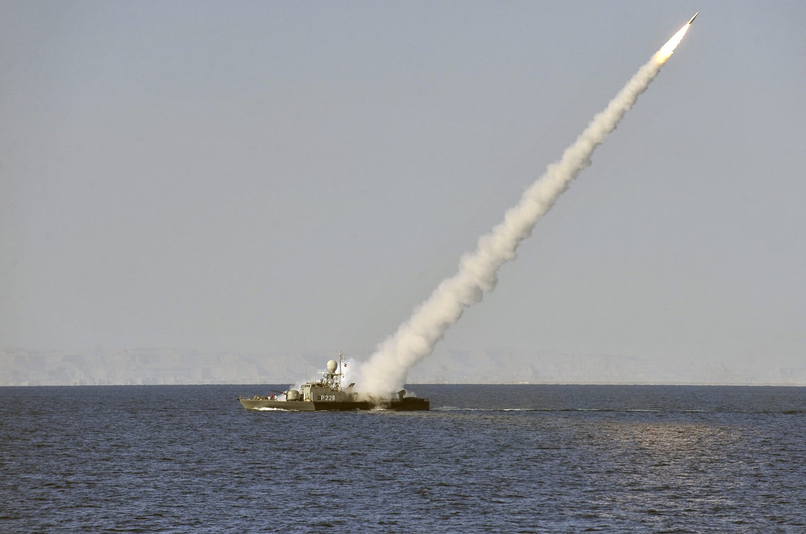 In this image made available by the Iranian Students News Agency, an Iranian Navy vessel launches a missile during a drill in the Sea of Oman, Jan. 1, 2012. (AP File Photo)