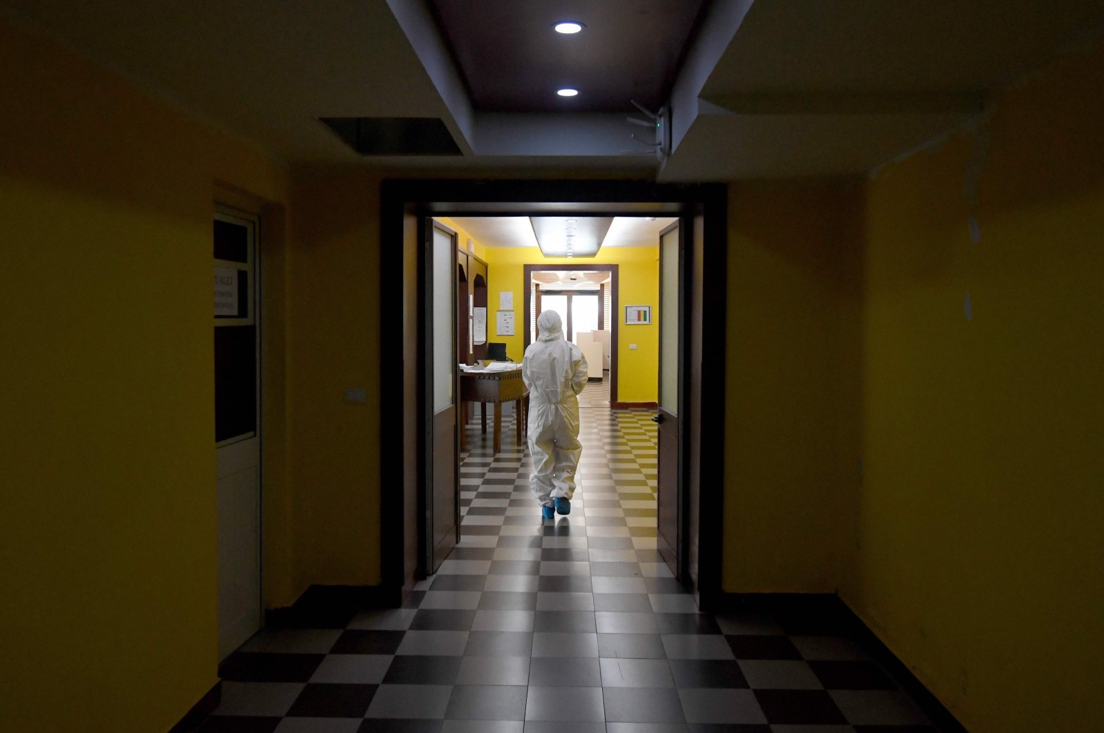 A medical worker walks through a corridor at the Shefqet Ndroqi Sanatorium hospital converted to receive patients infected with COVID-19 in Tirana, Albania, April 30, 2020. (AFP Photo)