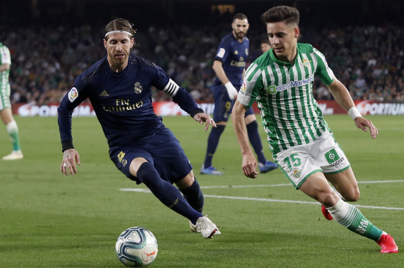 Real Madrid's Sergio Ramos fights for the ball against Betis' Alex Moreno during a La Liga match in Seville, Spain, March. 8, 2020. (AP Photo)